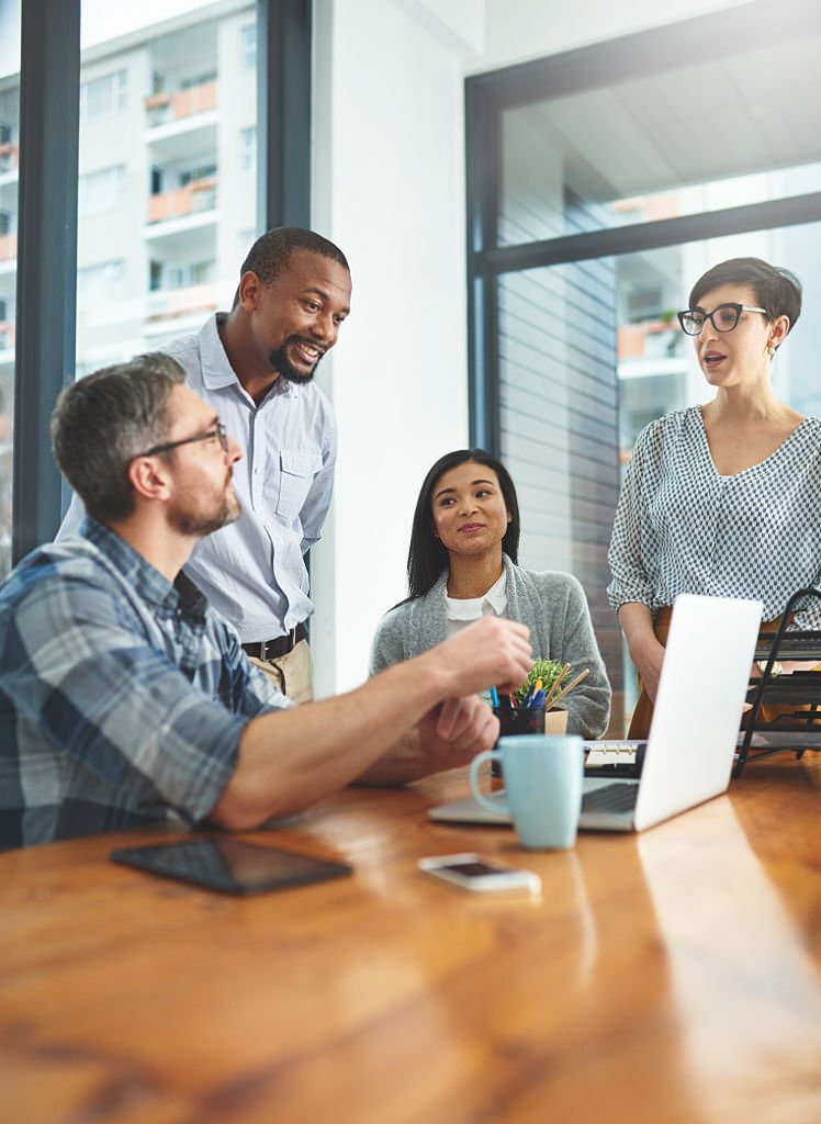 working together on a laptop in a modern office